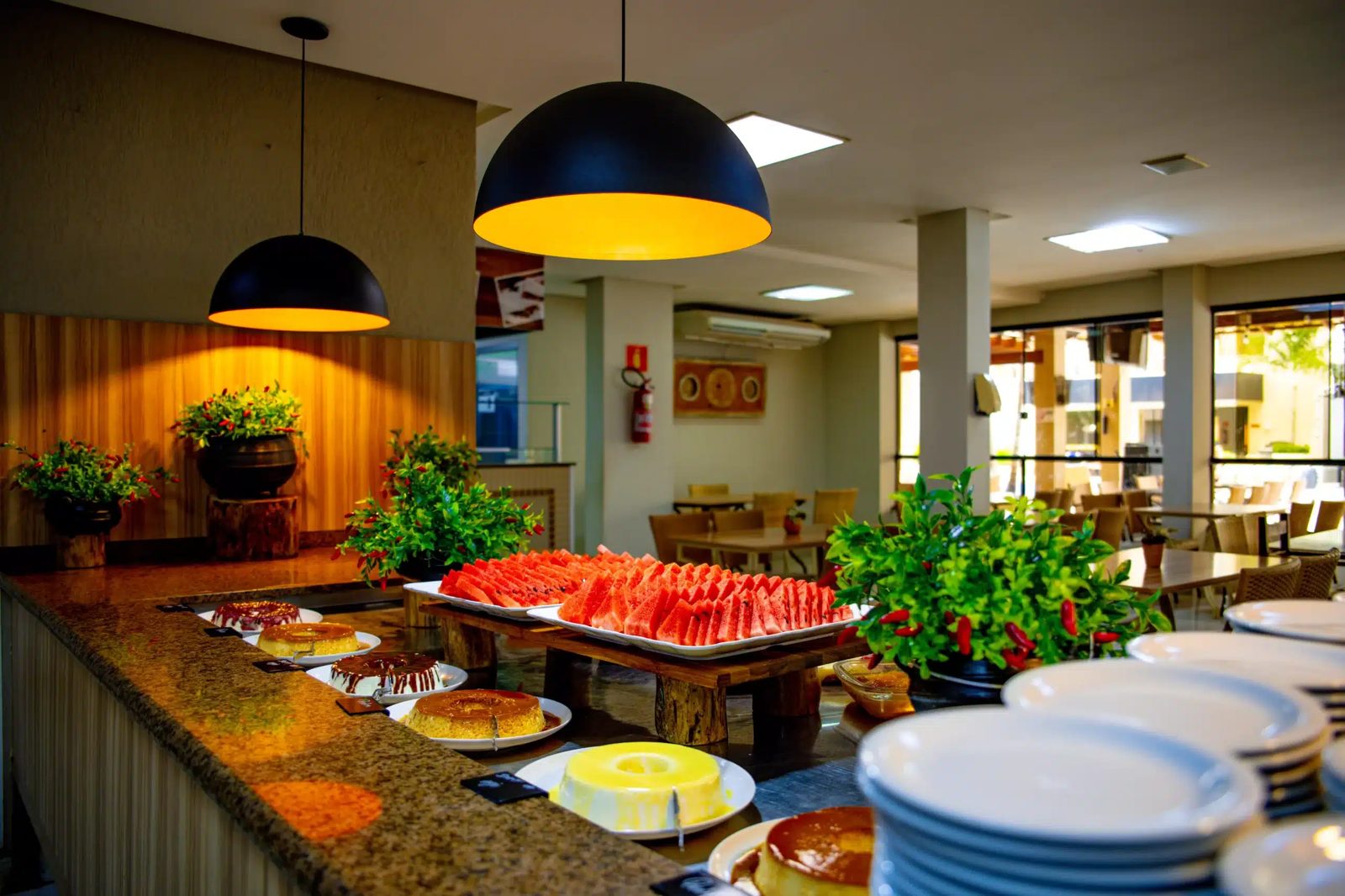 Buffet do restaurante do Boulevard Suíte Hotel com frutas, pães e pratos quentes